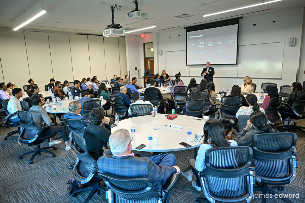 UTD workshop attendees gathered around tables during a presentation